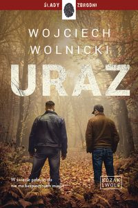 Okładka książki „Uraz" Wojciecha Wolnickiego, drugi tom serii kryminalnej Kozak i Wolf, Wydawnictwo Dolnośląskie